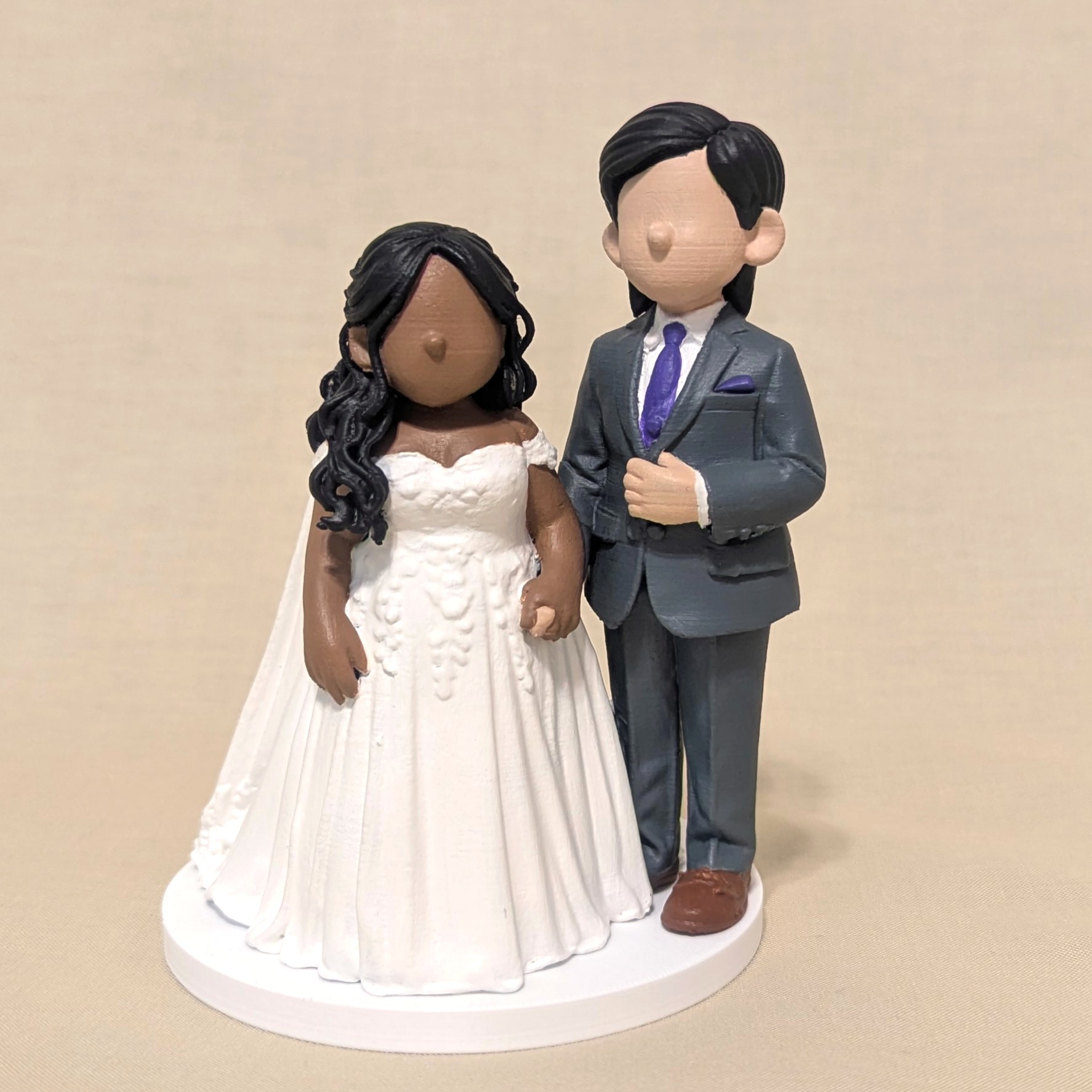 Personalized wedding cake topper sculpted to match the couple's likeness